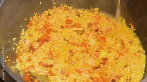 cooking KULESH, millet porridge. onions, meat and lard are cooked in a cast-iron cauldron over a fire