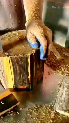 cutting wood log with vertical band saw machine creates thin planks on carpentry workshop table
