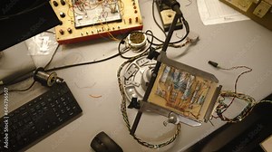 Pan across an electronics lab workbench with circuit boards.