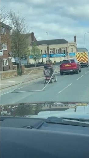 OAP on mobility scooter drags fence down busy road 😳 #shorts #funny #roadsafety