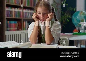 Overload Caucasian little girl child kid holding head feeling headache reading book school knowledge study failure exhausted sad schoolgirl pupil read worried learn homework lesson learning studying