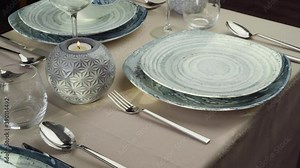 Close up of woman setting table. Hand of waitress or housewife putting silverware on dining table