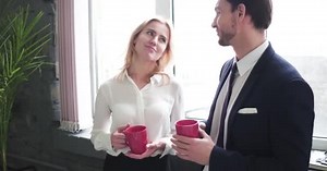 Young woman flirting with man at work