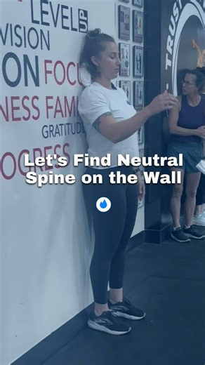 Neutral spine position refers to the natural curve of the spine that puts the least amount of stress on the tissues in the spine. The spine forms a soft s-shaped curve where the neck is slightly extended or concave, the upper back is slightly flexed or rounded, and the low back is slightly extended or concave. We can use a wall to help us find a neutral spine position and train ourselves to be in this position, which can be difficult because so many activities like sitting for work, driving, loo
