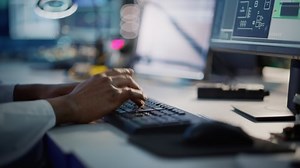 Modern Electronics Research, Development Facility: Engineer Working on Computer, Typing with His Hands on a Keyboard. Scientist Design PCB, Silicon Microchips, Semiconductors. Closeup Focus on Hands