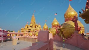 Wide angle shot of beautiful golden Swaminarayan temple of Varnindradham, Patdi, Gujarat. Nilkanth Swaminarayan Temple. Modern Hindu temple architecture.