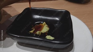 wasabi sauce mixed with oil using chopsticks