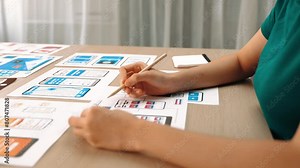 Panorama video of startup UX developer or company employee design user interface or UI prototype for mobile application or website software with software display on smartphone in office. Synergic