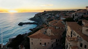 Scenic Mediterranean Town on a Cliff at Sunset: A Serene Coastal Landscape