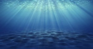 Beautiful underwater sea view and ripples with sun light beams shining from above.