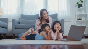Asian family with children using laptop computer at home