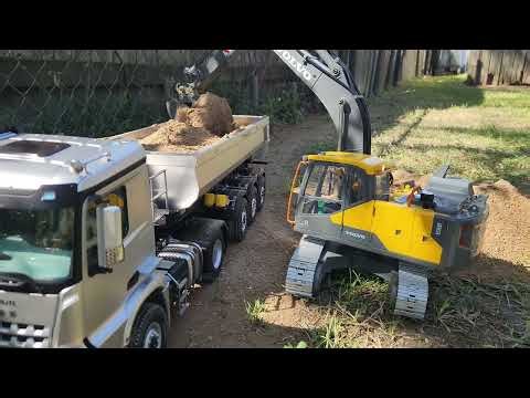 Rc kabolite dump truck carrying dirt on a nice day.