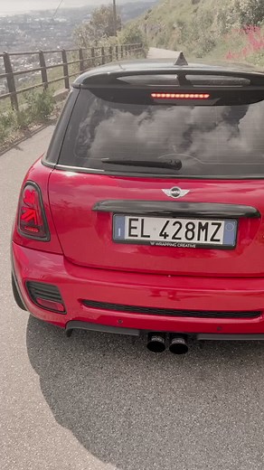 Red Mini Cooper Driving on Scenic Winding Roads