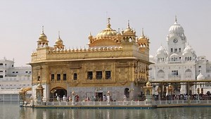 Amritsar, India: Aerial view of famous city in Punjab, iconic landmark The Golden Temple (Harimandir Sahib) - landscape panorama of South Asia from above