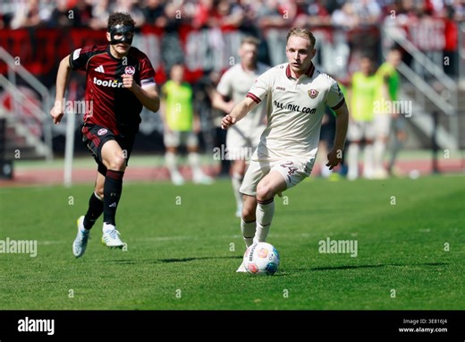 v.l.n.r.: Fabio Gruber (1. FC Nürnberg) and Tony Menzel (Dynamo Dresden), im 2. Bundesliga-Spiel zwischen dem 1. FC Nürnberg und der SG Dynamo Dresden im Max-Morlock-Stadion, Nürnberg, Deutschland, am 11. April 2026. in action during the 2. Bundesliga match between 1. FC Nürnberg and SG Dynamo Dresden at the Max-Morlock-Stadion, Nuremberg, Germany, on April 11, 2026. DFL REGULATIONS PROHIBIT ANY USE OF PHOTOGRAPHS AS IMAGE SEQUENCES AND/OR QUASI-VIDEO. (Photo by HMB Media/ Heiko Becker/Sipa USA 