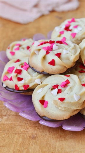 If you make butter cookie dough and find it too firm to pipe, just microwave the dough. Heat in a microwave safe bowl in ten second increments, stirring after each, until the dough is smooth enough to spread around the bowl. This won’t cook the dough, but it will soften the dough and make it possible to pipe. I made the dough in the video with cold ingredients to test the technique and am happy to say that it works! Piped Butter Cookies Makes about 30 cookies 18 Tablespoons (250g) unsalted butte