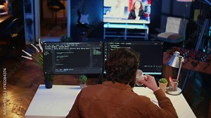 Admin using javascript coding language to fortify security and safeguard consumer data, remotely working for IT company. Software developer upgrading binary code scripts on computer terminal, camera B