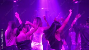 cheering crowd at a music party concert. people man and woman dancing on floor with musician performance on stage with lighting effect. Young people in the club, partying and enjoying the nightlife. Stock Video