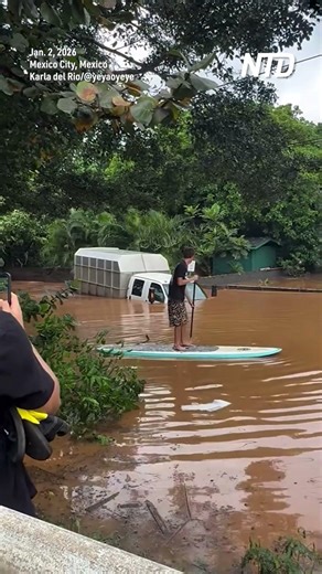 Bystanders Shout at Truck Driving into Flood Waters