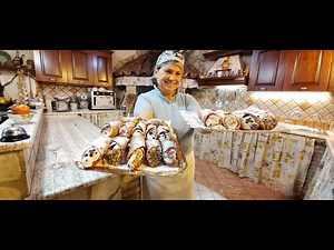 Sicilian cannoli with chopped hazelnuts, chopped pistachios, candied fruit, and chocolate chips.