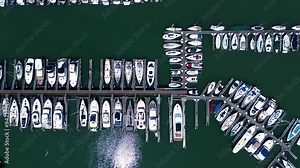 Drone aerial bird's-eye view of yachts sail boats ships floating in harbour marine bay area dock pier coastline Sausalito community California USA America travel holidays transport