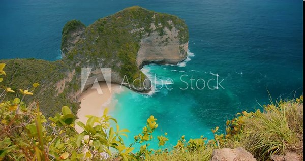 Famous T Rex shaped cliff overlooks the white sand of Kelingking Beach in Nusa Penida Bali