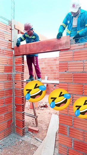 Construction Workers Building a Brick Wall