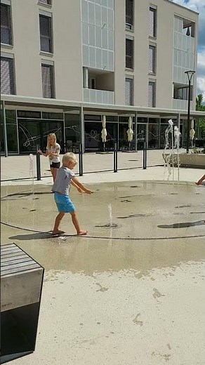 Kids are cooling off and playing in the water fountain!