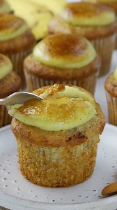 A soft Banana Cupcake is filled with the most delicious and creamy Banana Pudding, which is also used to top the cupcakes, and then gets sprinkled with sugar and blasted with a blowtorch to caramelized, crackling perfection, resulting in an awe-inspiring creation. 🍌 Check out this amazing recipe here: https://www.piesandtacos.com/banana-creme-brulee-cupcakes/ | Pies and Tacos