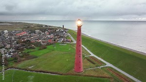 Lighthouse tower Lange Jaap in Den Helder drone aerial footage 5K along the sea near the island of Texel in North Holland, The Netherlands.