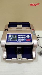 Mixed note value counting machine with fake note detection and printer. Description: 1. It shows denomination wise counted pieces and total value. 2. Denomination sort function. 3. Detects counterfeit/fake notes using UV, MG, IR, 3D, and Colour detection while counting. 4. Modes of operation: MIX Mode, SORT Mode, DETECT Mode, COUNT Mode, BATCH Mode, ADD Mode. 5. Can connect a thermal printer and get a detailed report of counted notes. The report shows denomination-wise counted pieces and total v