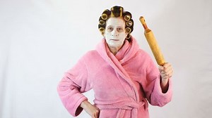 Angry wife with a rolling pin in hand