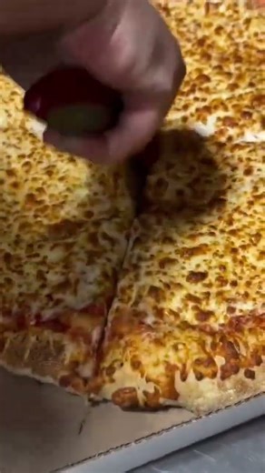 cutting a pizza using a cutter into several pieces#youtubeshorts