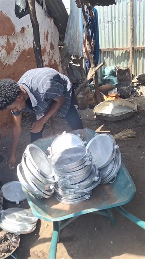 Organizing Metal Pots in a Rustic Outdoor Setting