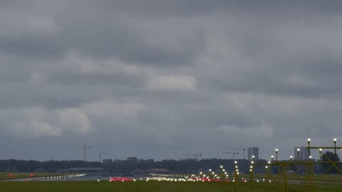 clip-3996716303-airplane-descending-landing-on-runway-approach-lights