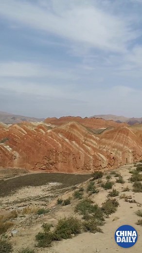 The crimson tie-dye colored hills of Zhangye Danxia Landform Geological Park in NW China's Gansu province attract tens of thousands of tourists from home and abroad every day. | China Daily