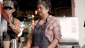 Elderly aging society health care capability working, 60s retirement senior woman start small business cafe coffee shop employed Asian barista female worker employee or happy working with daughter