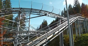 Alpine slide or rodelbahn in Bukovel - village and largest ski resort in Carpathian Mountains, Ivano-Frankivsk Oblast, western Ukraine. Cinema 4K 60fps video