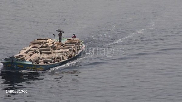 Boats navigate through the polluted waters of the Buriganga river on...