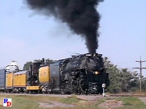 After waiting for a diesel powered freight to pass, Challenger #3985 grabs her freight and along with a museum donation bound for the Durham Museum in Omaha, Nebraska, continues east. From the WB Video Productions show "Union Pacific Super Cabs and Steam" https://rfd.video/Supercabs | Steam Giants