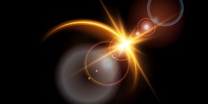 The edge of a golden solar eclipse on a black background. Golden...