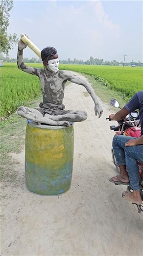 The statue was sitting with a stick in its hand.