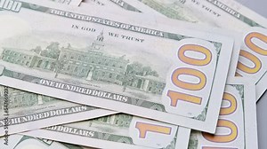 American one hundred dollar paper money pile rotating on office desk. Finance and investment concept. Cash money banknotes. Pile of american dollars. Close-up in 4K, UHD