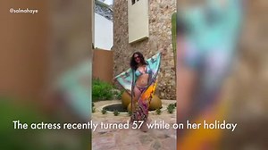 Salma Hayek twirls in a graphic bikini on vacation