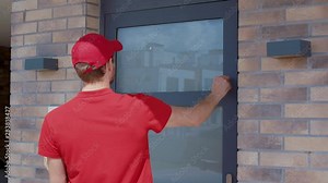 Fast pizza delivery. View young courier carrying pizza boxes knocking on door waiting for customer. Handsome positive man opening door taking order paying with credit card.