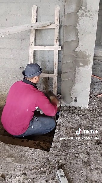 Construction Worker Demonstrates Cement Application Techniques