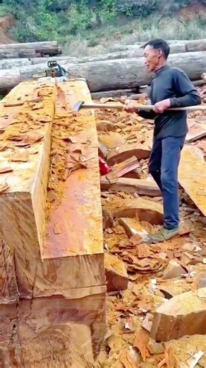 splitting cutting shaping large wood log using chainsaw removing bark creating flat surface boards