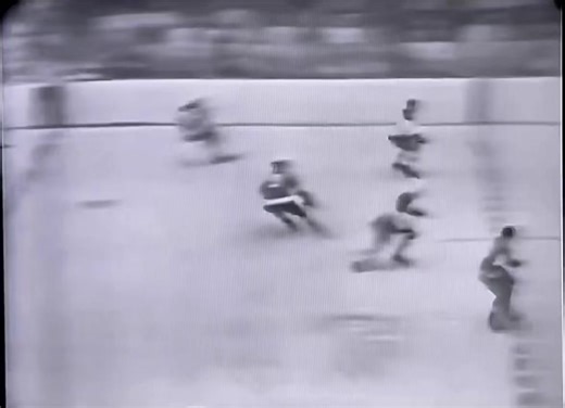 April 16, 1963. #Olympia Stadium in #Detroit. #Leafs goalie Johnny Bower muffs a long shot from Gordie Howe early in Game 3 of the #StanleyCup final. #RedWings would even the series but lose in six to the best club of the Punch Imlach dynasty. Bill Hewitt calls the play.