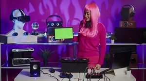 Smiling dj holding green screen chroma key mock up tablet with isolated display while mixing techno sound with electronic promoting new albun in nightclub. Musician using professional audio equipment