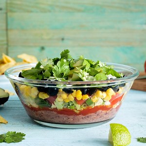 We can’t get enough of this colorful, guilt-free dip, topped with avocado and tofu sour cream. RECIPE: https://www.forksoverknives.com/recipes/vegan-snacks-appetizers/mexican-10-layer-dip-2/ | Forks Over Knives